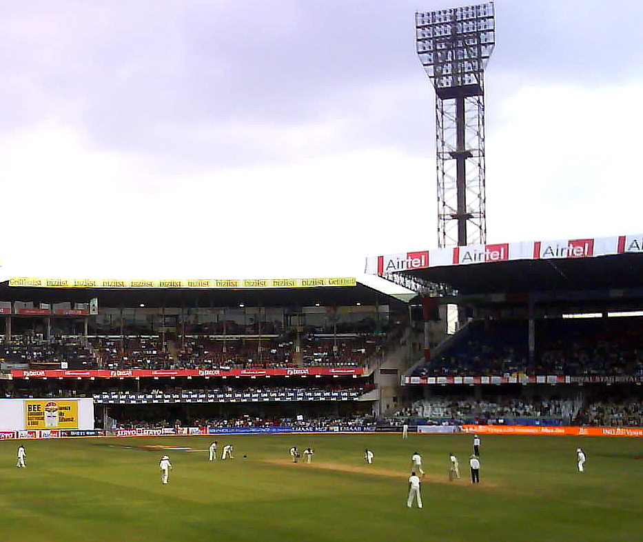 Floodlit cricket stadium filling up before an evening T20 match in India