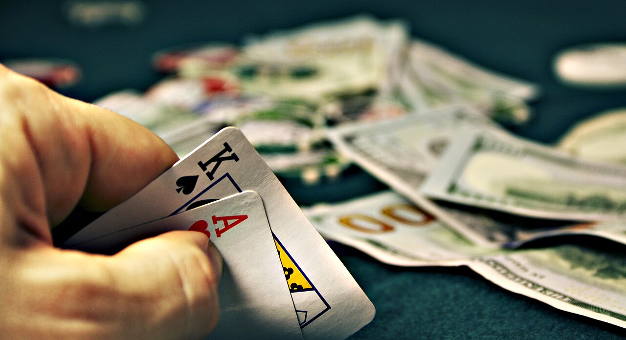 Chips and hole cards in front of a player at an online poker table layout