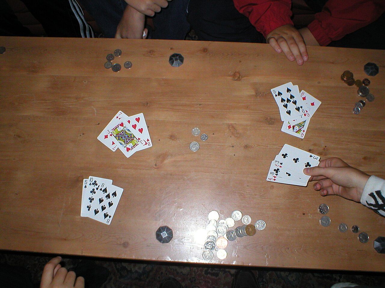 Three-card hands dealt face down on a live Teen Patti table